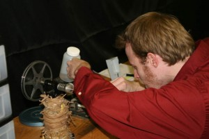 A person comparing DIY and professional film conversion services